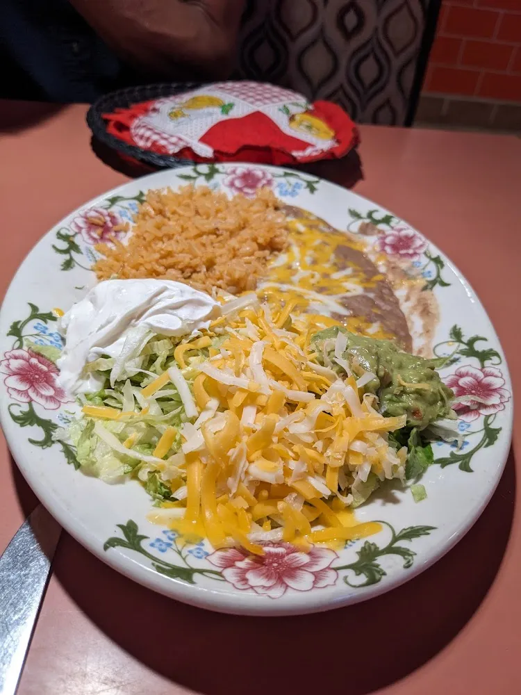 Rice Refried Beans Shredded Lettuce Cheese Guacamole and Sour Cream for the Beef Fajitas